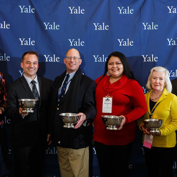 Alumni holding their AYA Leadership Award trophies. 